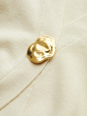 Gold button detail on cream cardigan