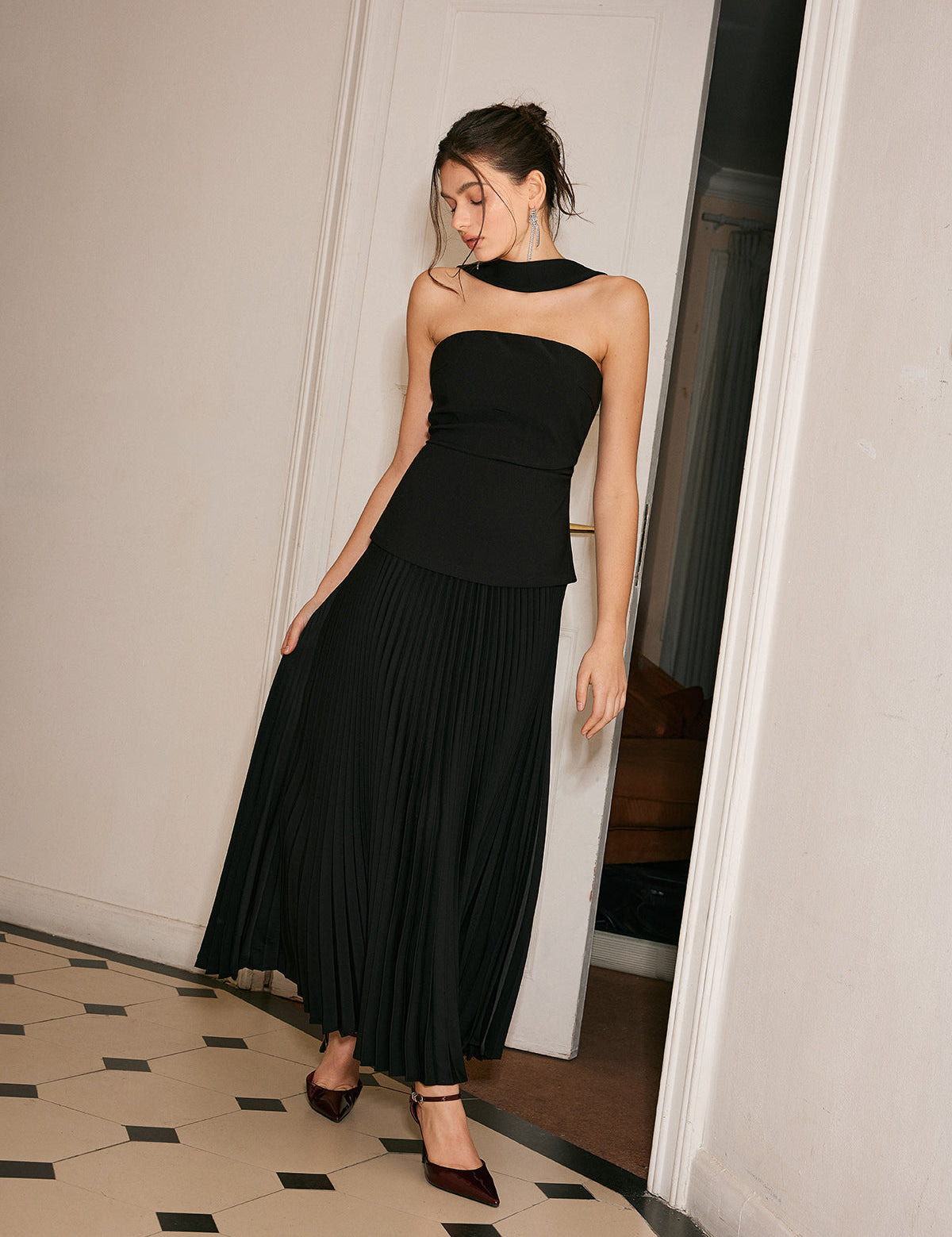 Black strapless evening dress with pleated skirt side profile view