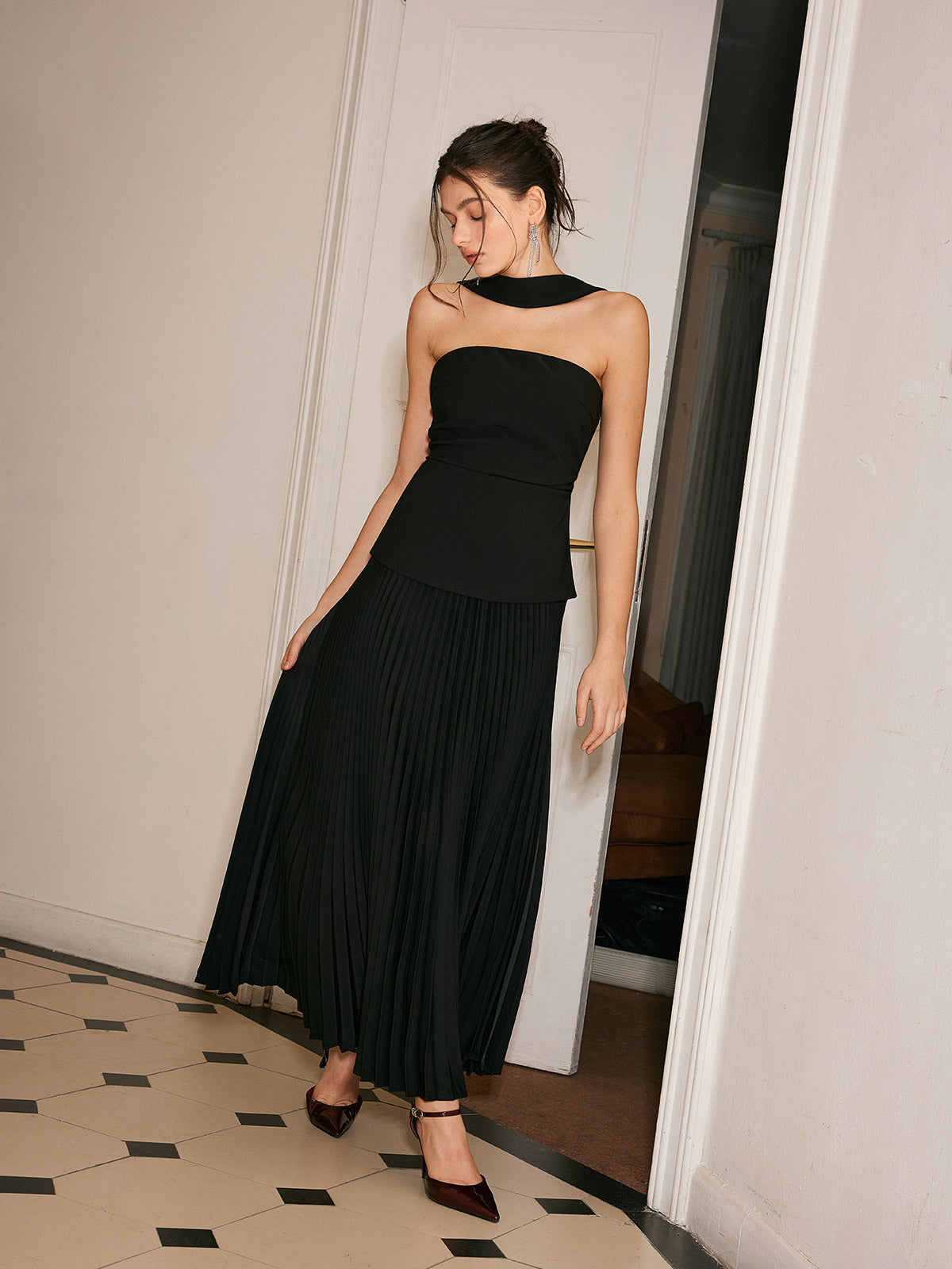 Black strapless evening dress with pleated skirt side profile view