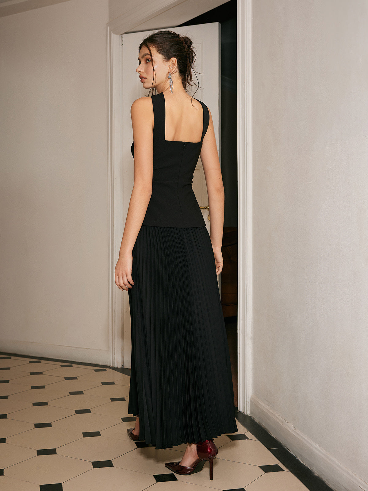 Black strapless evening dress with pleated skirt back view