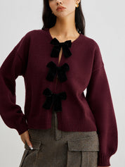 Cardigan burgundy with black velvet bows front view close-up