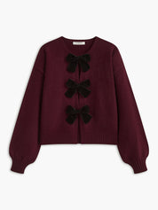 Cardigan burgundy with black velvet bows front view plain background