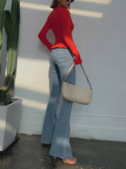 Red ribbed cardigan with white buttons three-quarter view