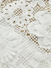 Close-up of white lace floral details