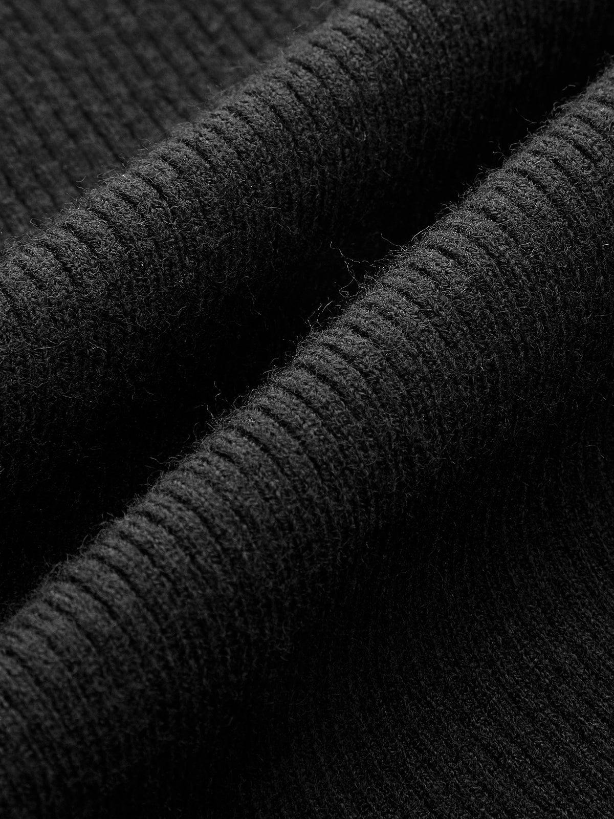 Black ribbed sleeveless top with sheer panel close-up front neck detail
