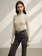 Khaki long-sleeve top with black belt and jeans full body