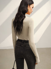 Khaki long-sleeve top with black belt and jeans back view