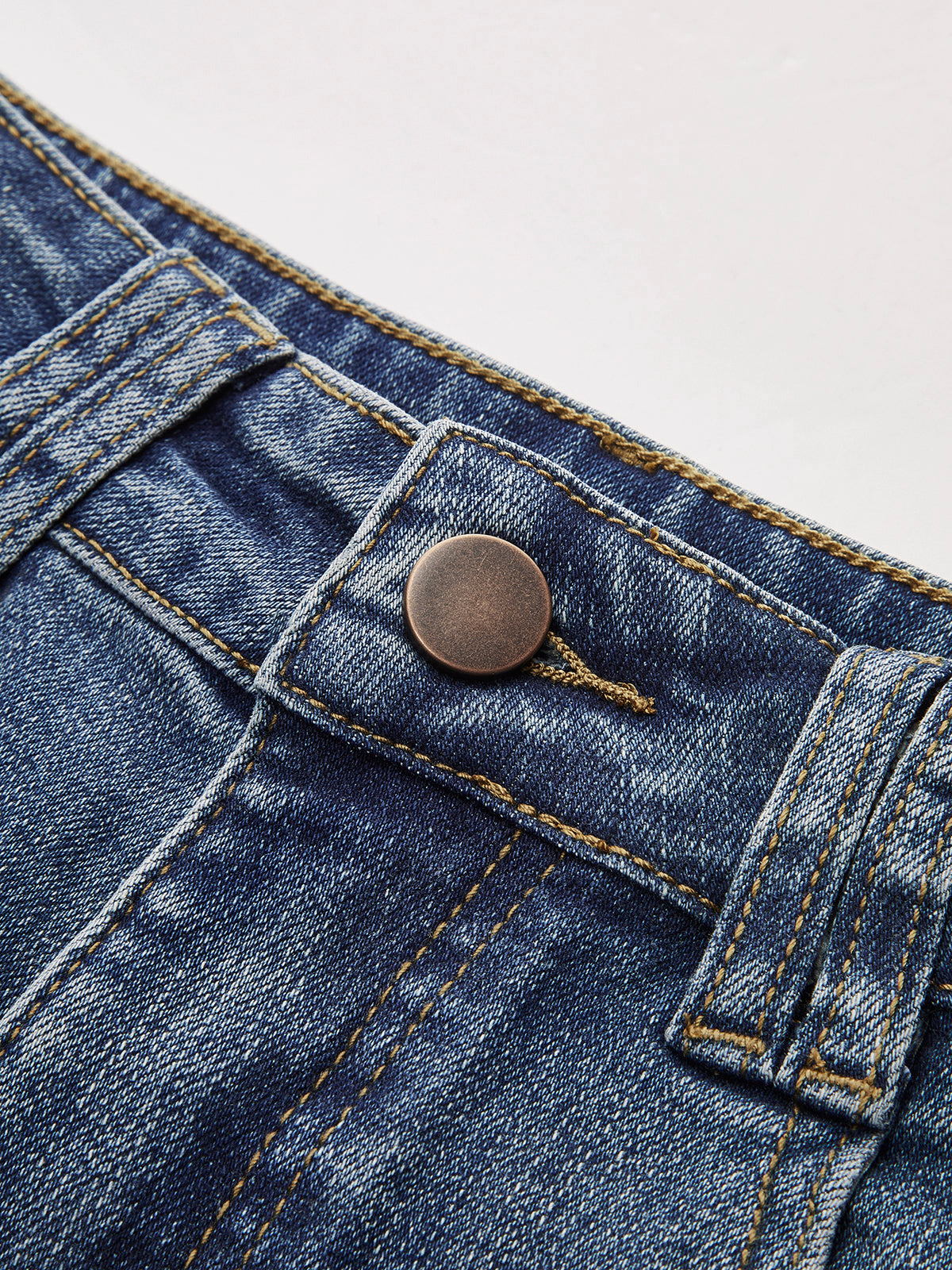 High-waisted wide-leg jeans blue close-up button detail