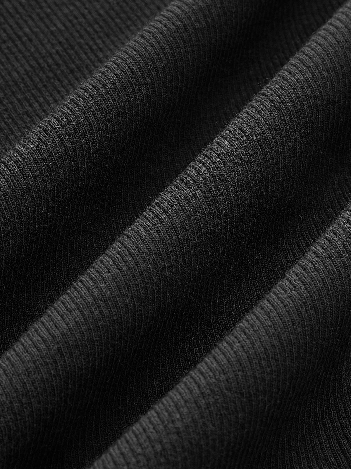 Black tank top with asymmetrical neckline fabric texture close-up