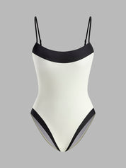White swimsuit with black contrast straps, front view
