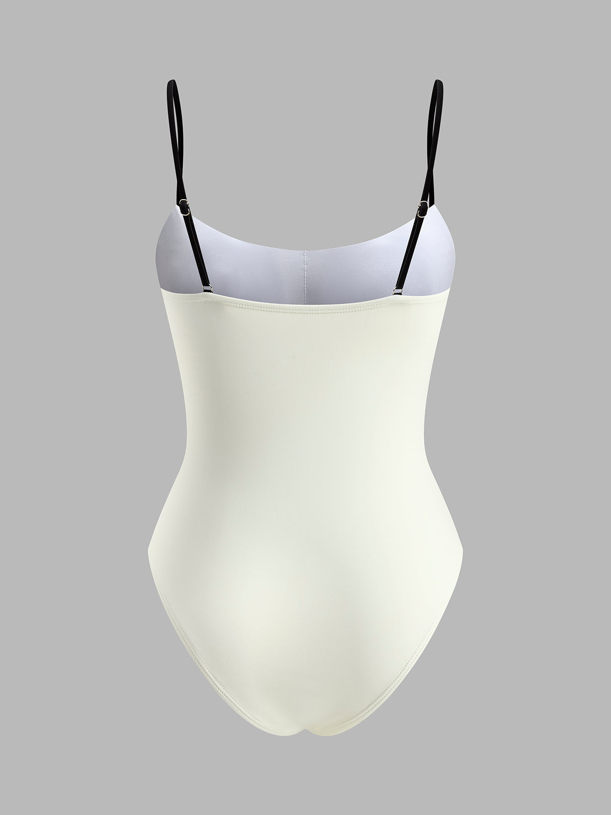 White swimsuit with black contrast straps, back view