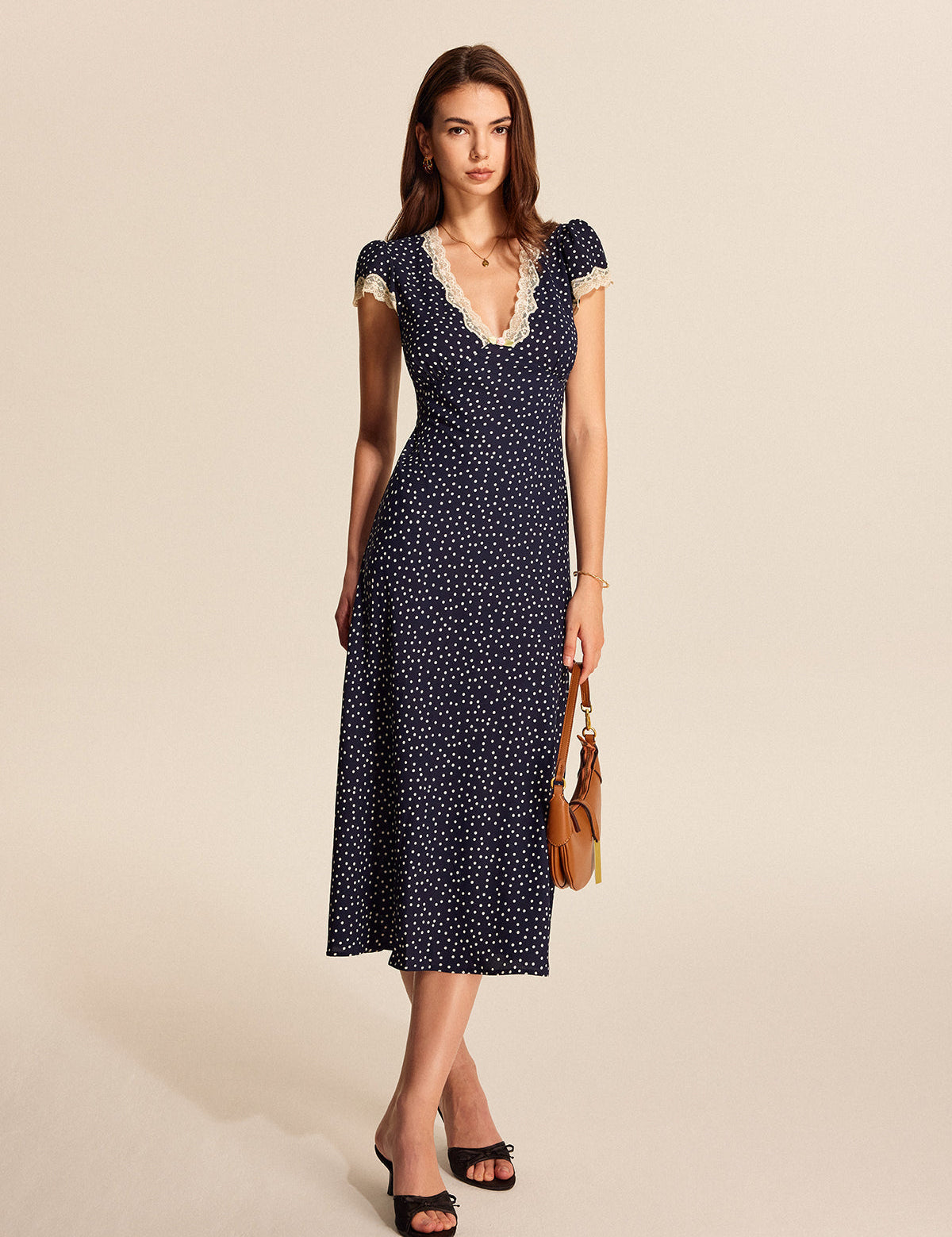 Midi dress navy blue with white polka dots and lace side profile