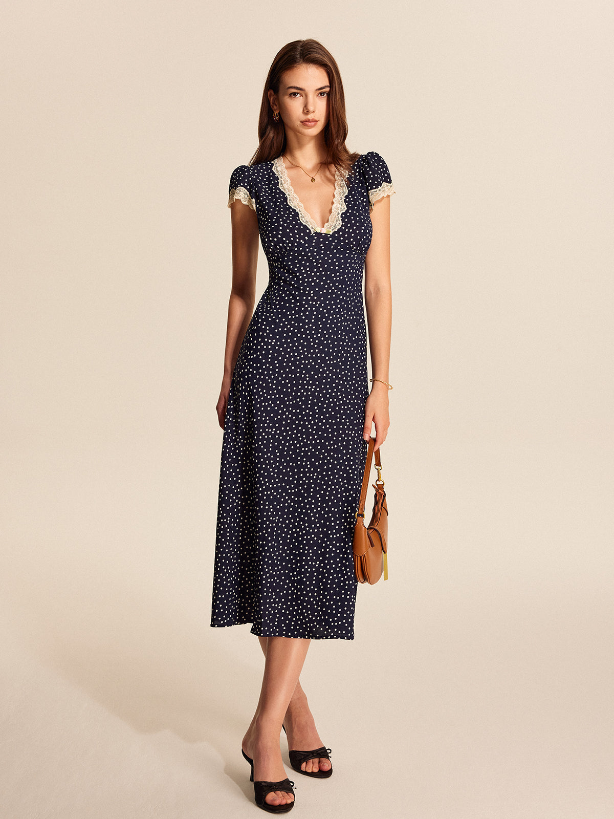 Midi dress navy blue with white polka dots and lace side profile