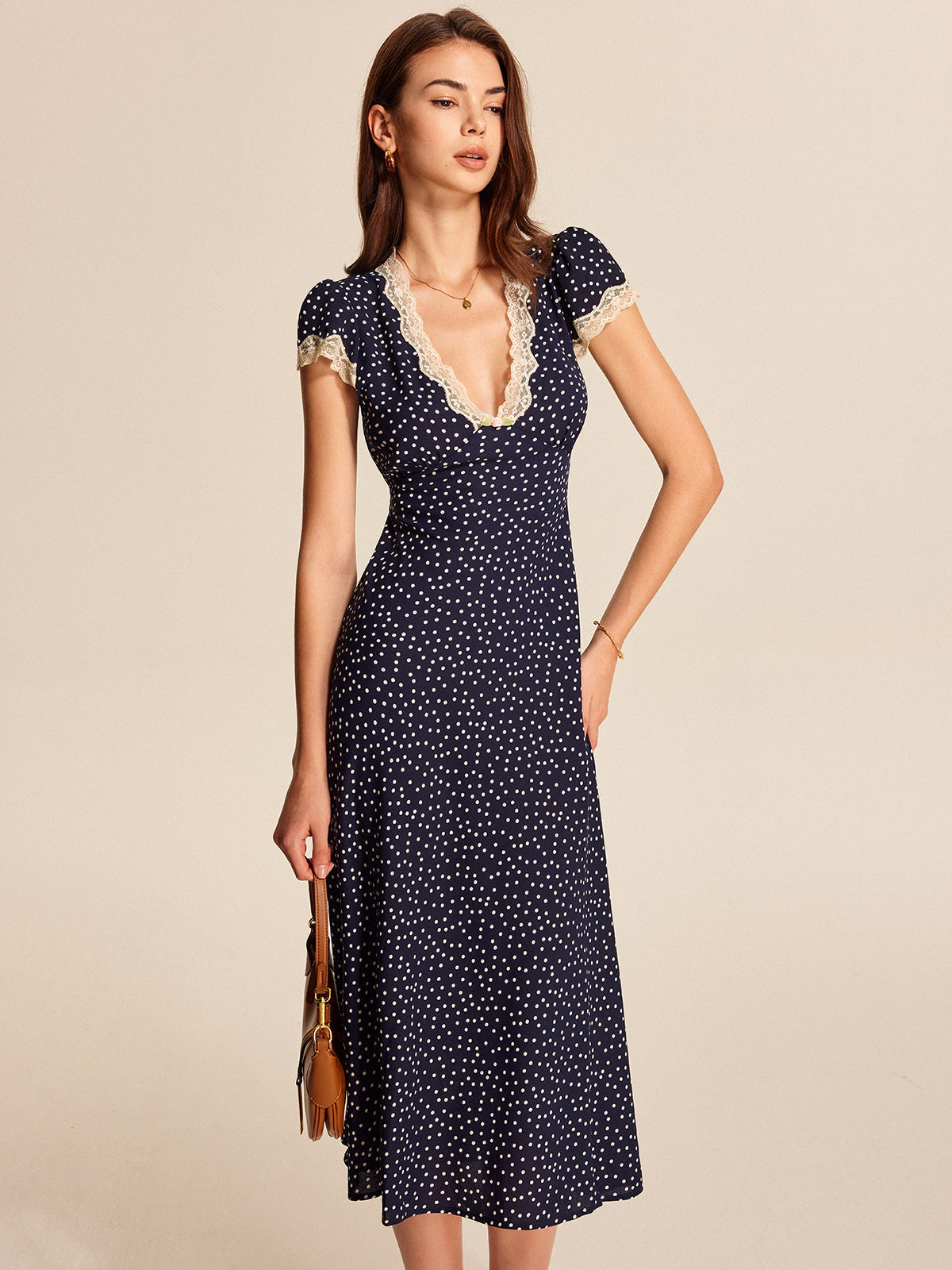 Midi dress navy blue with white polka dots and lace front pose