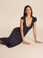 Midi dress navy blue with white polka dots and lace seated pose