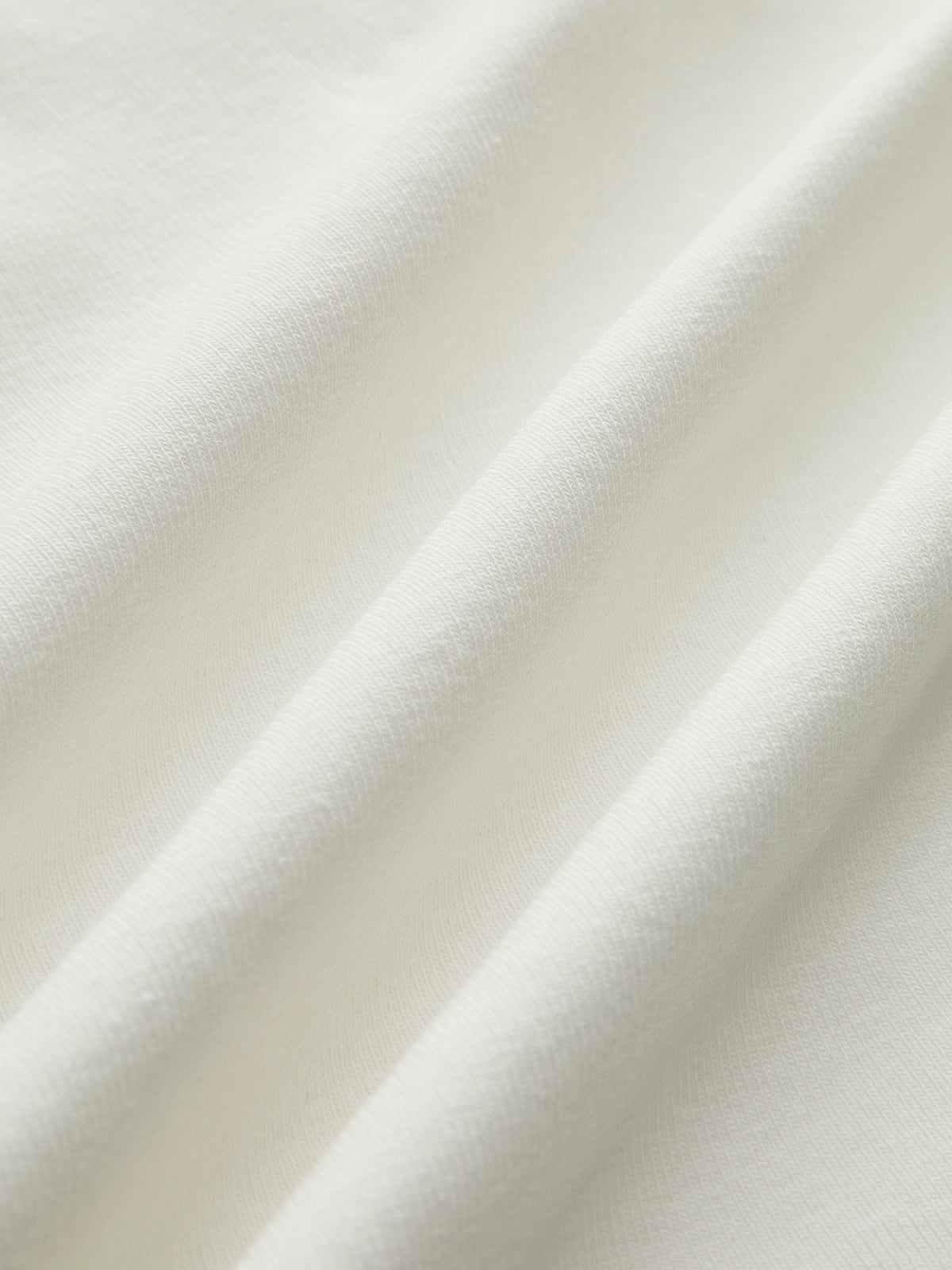 Close-up of white sleeveless mock-neck top fabric texture