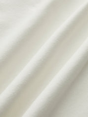 Close-up of white sleeveless mock-neck top fabric texture