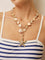 Necklace with gold starfish pendant and shell beads, front view on model