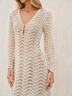 Cream lace dress with bell sleeves and button detail close-up