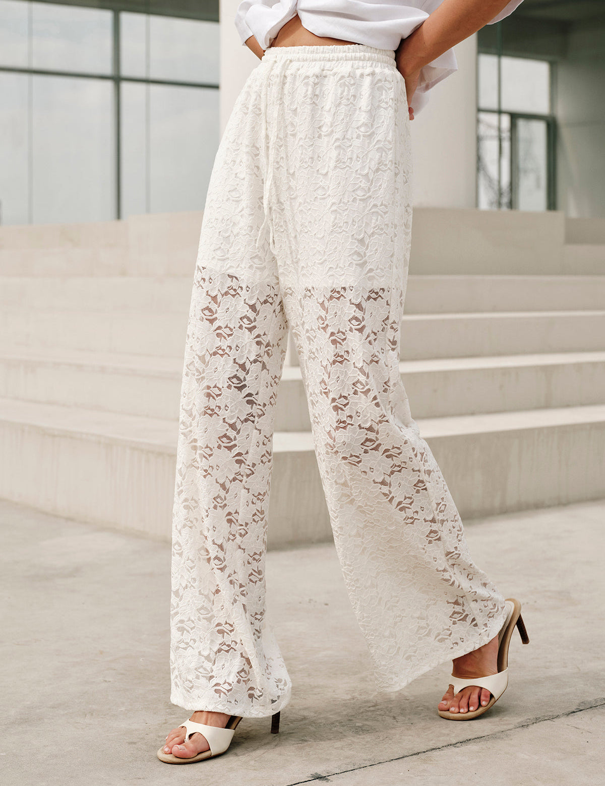 White lace pants with floral pattern close-up