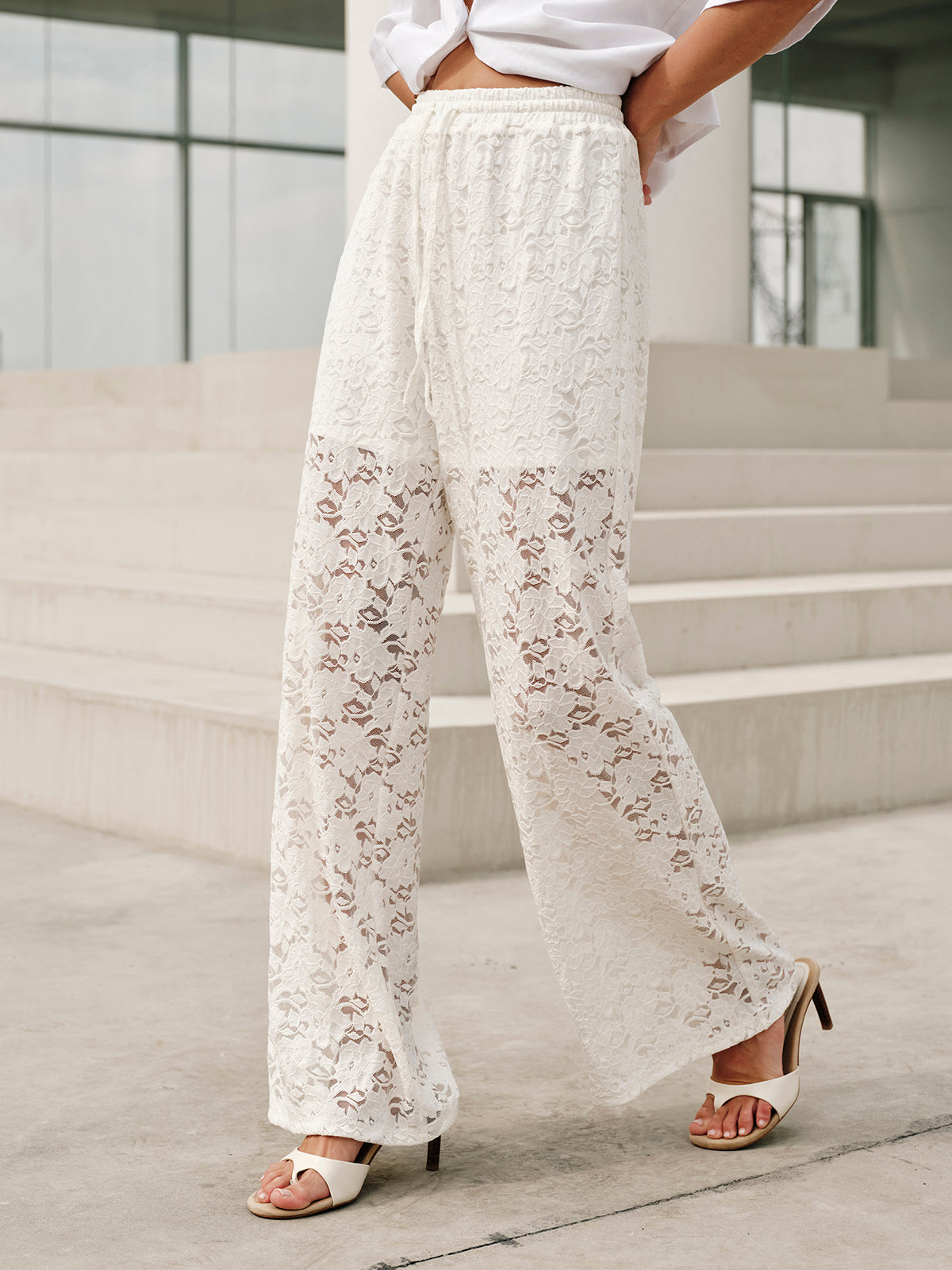 White lace pants with floral pattern close-up