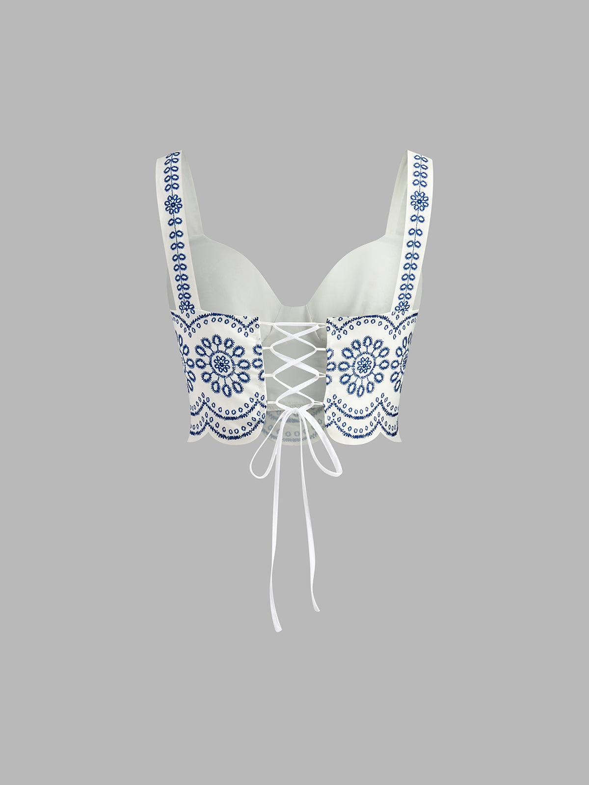 Top white with blue floral embroidery side view