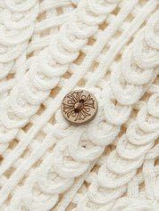 Detail of wooden button on crocheted vest