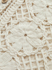 Close-up of cream crochet vest floral pattern detail