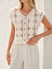 Cream crochet vest with floral pattern worn with gold jewelry