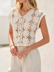 Cream crochet vest with floral pattern front view with hands on hips