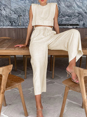 Beige two-piece set with crop top and wide-leg pants seated pose