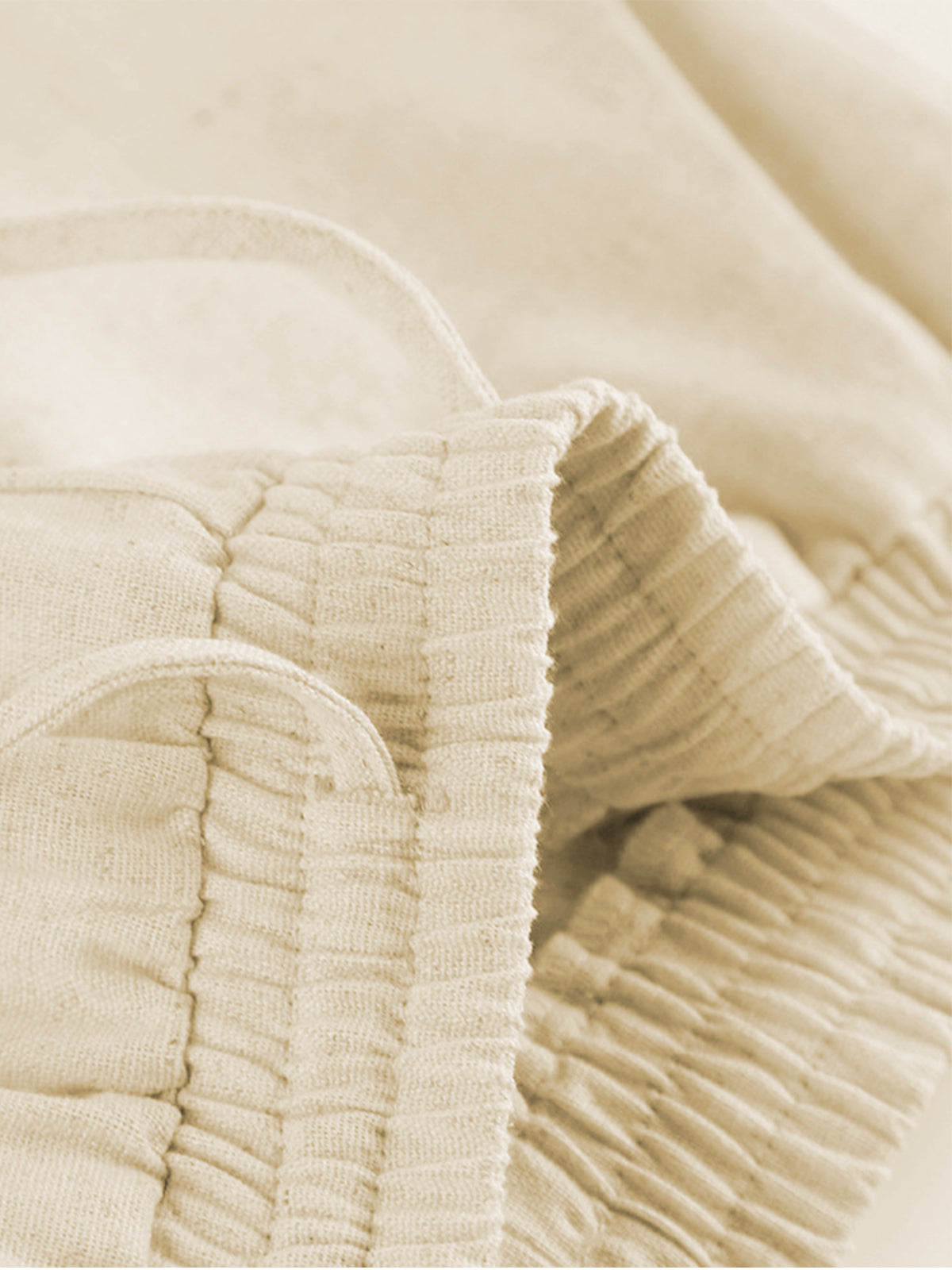 Beige two-piece set waistband detail close-up