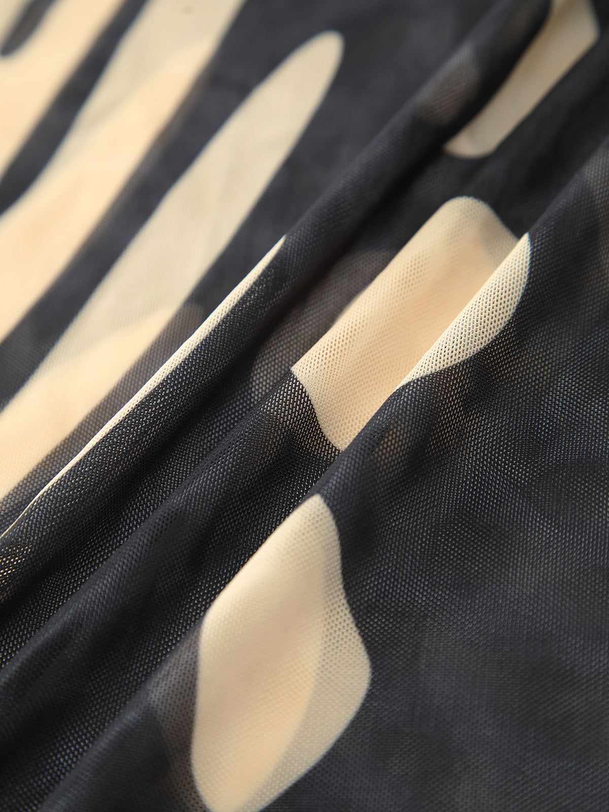Maxi dress with cutouts and tropical print fabric texture close-up