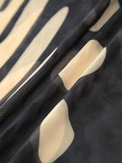 Maxi dress with cutouts and tropical print fabric texture close-up