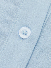 Close-up of light blue linen co-ord set buttons