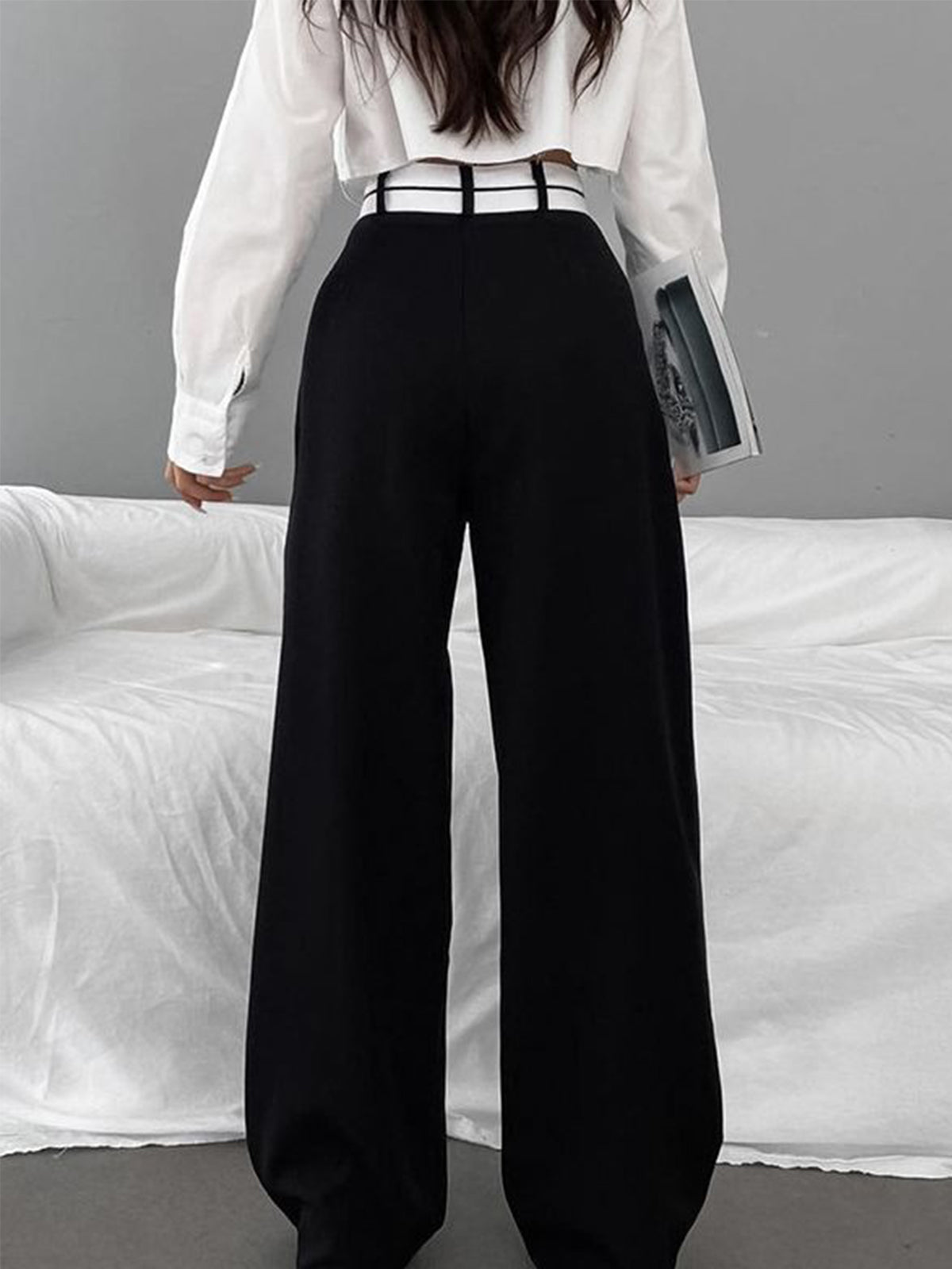 Wide-leg black pants with white waistband back view