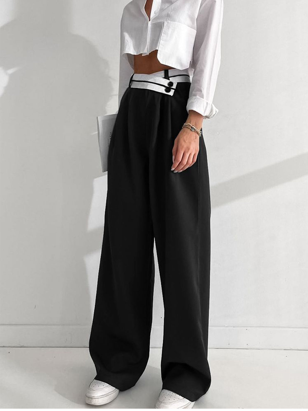 Black pants with white waistband and black buttons front view