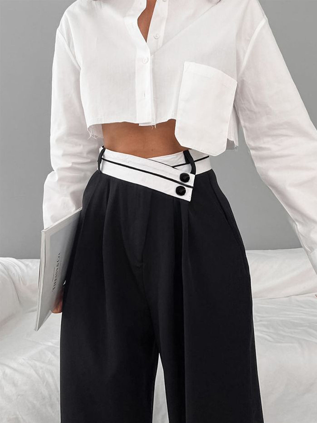 Black pants with white waistband and black buttons close-up front view