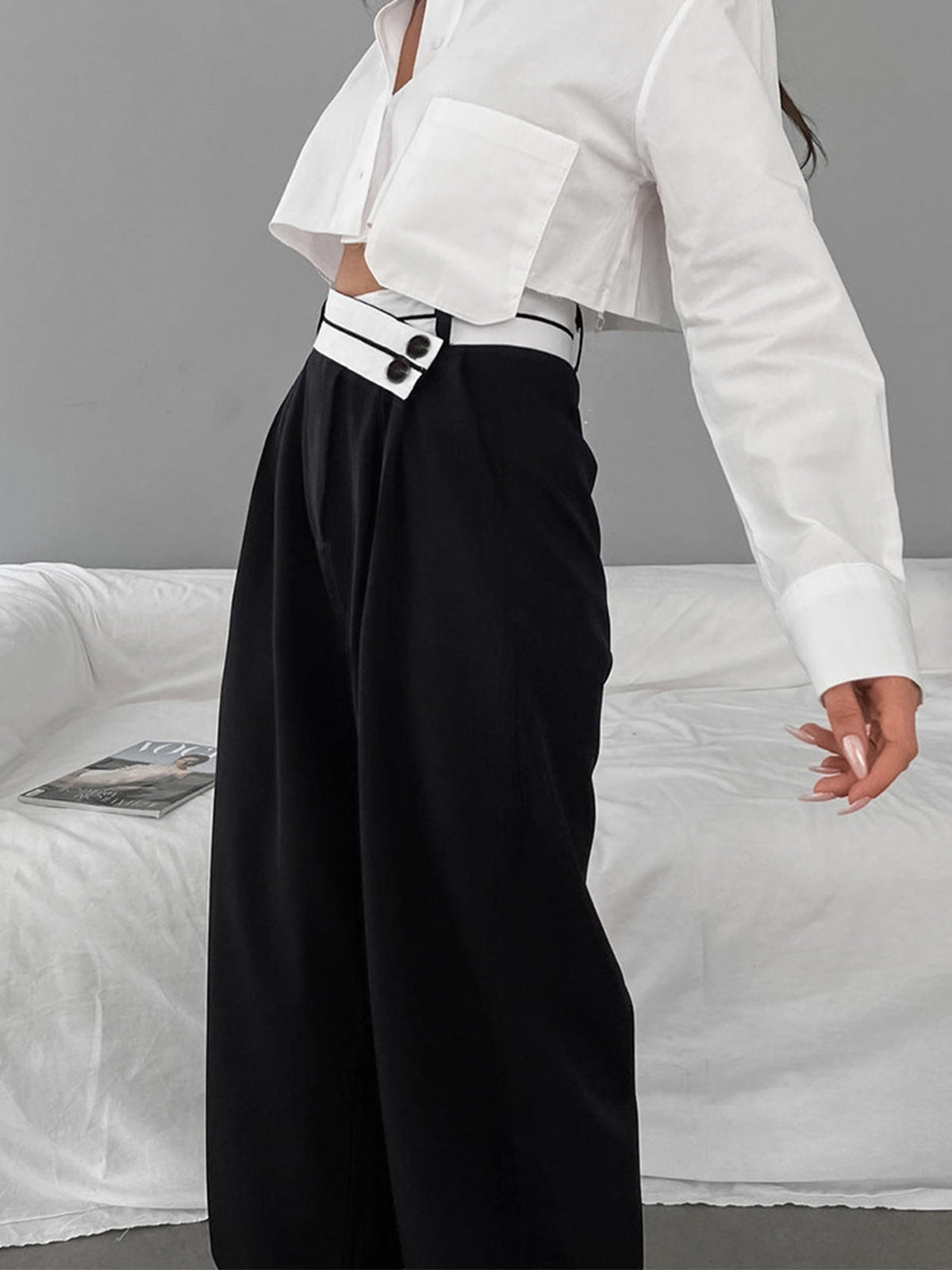 Wide-leg black pants with white waistband side view