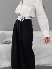 Wide-leg black pants with white waistband side view