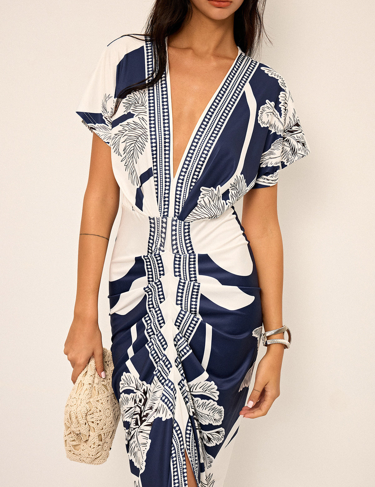 Dress with deep V-neck and tropical print, side profile