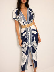 Dress with deep V-neck and tropical print, side view with belt