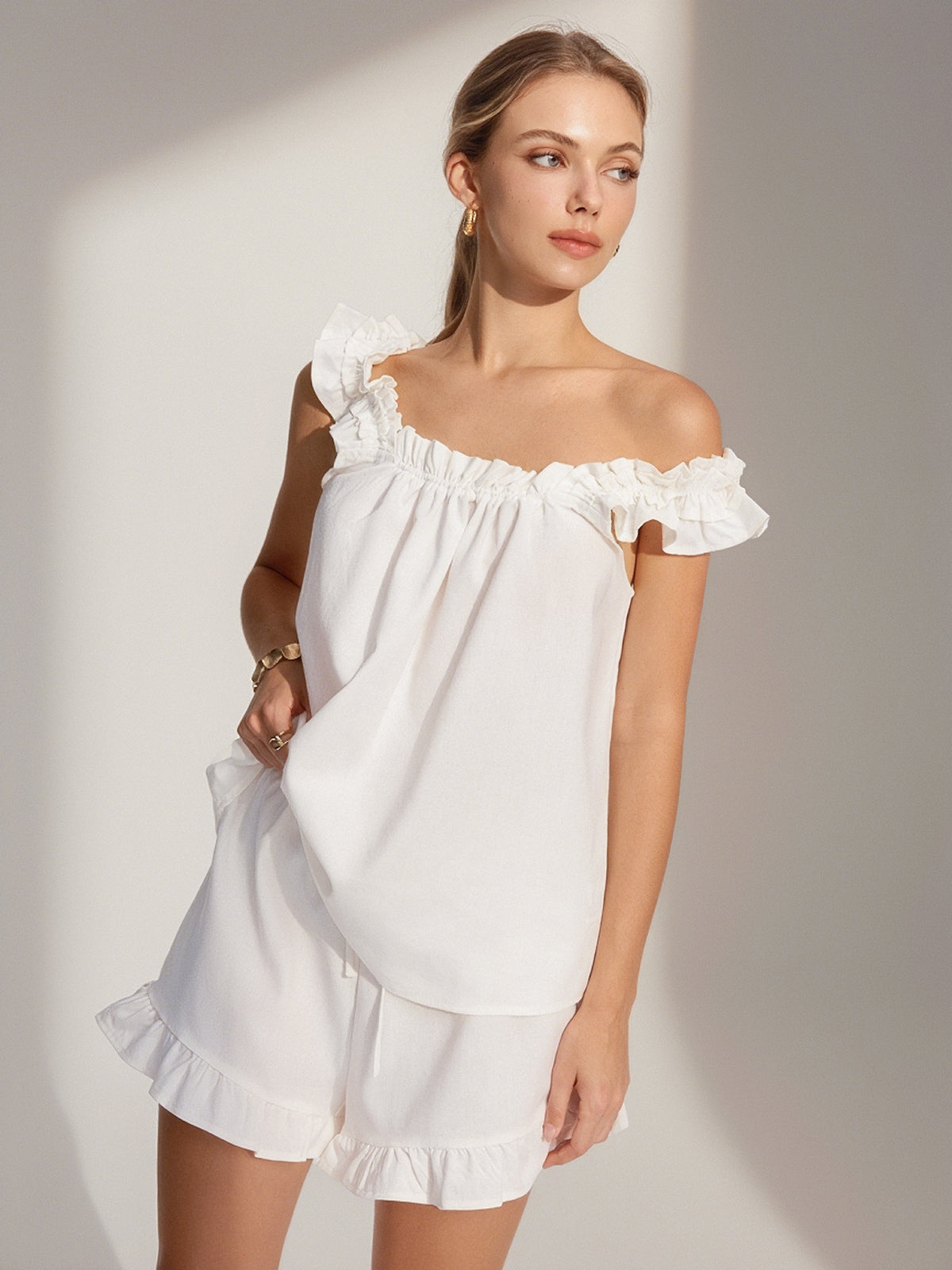 White loungewear set with ruffle details off-the-shoulder front view