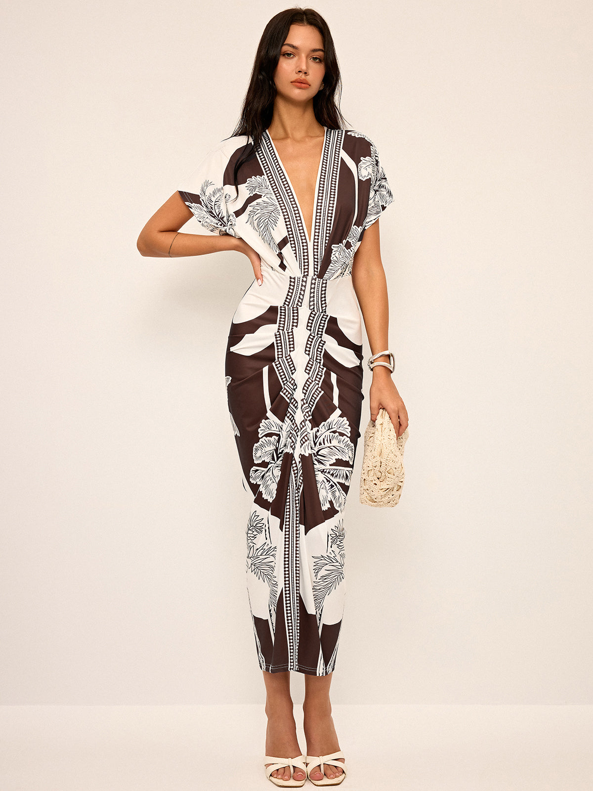 Dress with deep V-neck and tropical print, front view in brown and white
