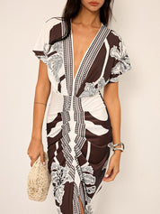 Dress with deep V-neck and tropical print, side profile in brown and white