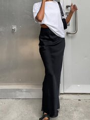 Black satin maxi skirt with flared hem front view