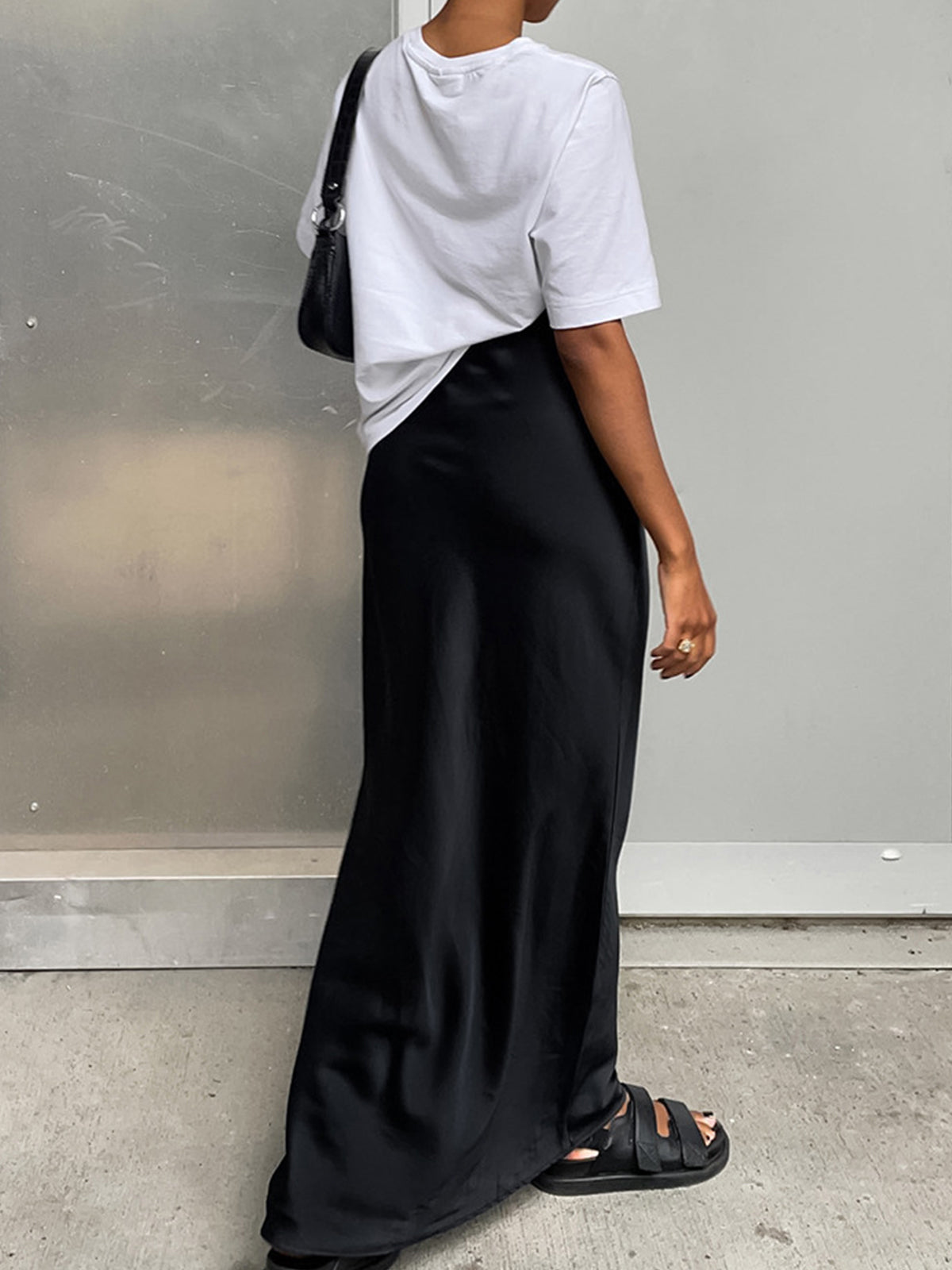 Black satin maxi skirt with flared hem back view