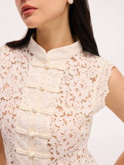 Cream lace blouse with pearl buttons close-up detail