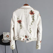 White leather jacket with floral embroidery and studs, back view