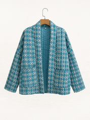 Women's jacket with green and white pattern, hanging front view